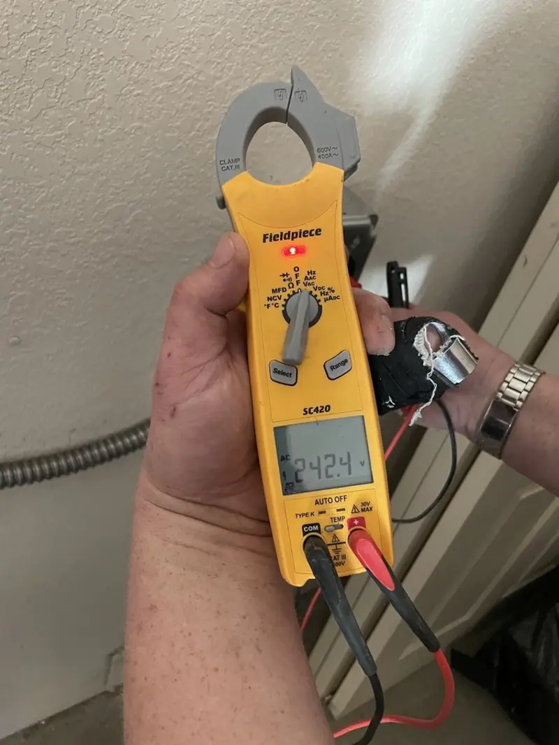 Voltage testing with clamp meter during Ceiling Fan Installation in St. James